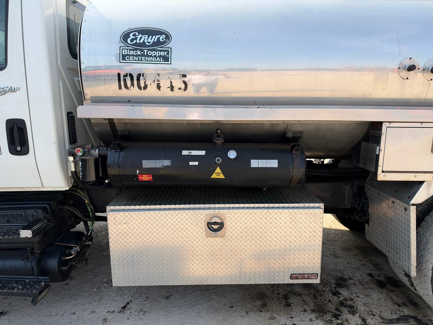 Etnyre Black Topper Centennial 2,000-gallon asphalt distributor propane heat system and tank detail — RoadKing Rentals Texas